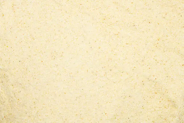 Photo of Semolina, close up, macro, top view. Popular flour in cooking. Used for making of pasta or couscous or as baby food.