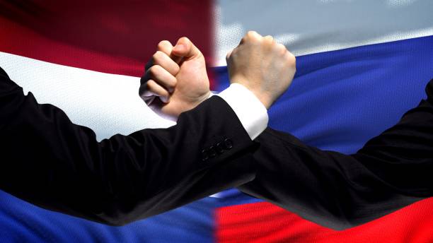 istock Netherlands vs Russia confrontation interests conflict, fists on flag background 1087934526