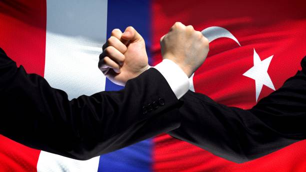 istock France vs Turkey confrontation, countries disagreement, fists on flag background 1087936592