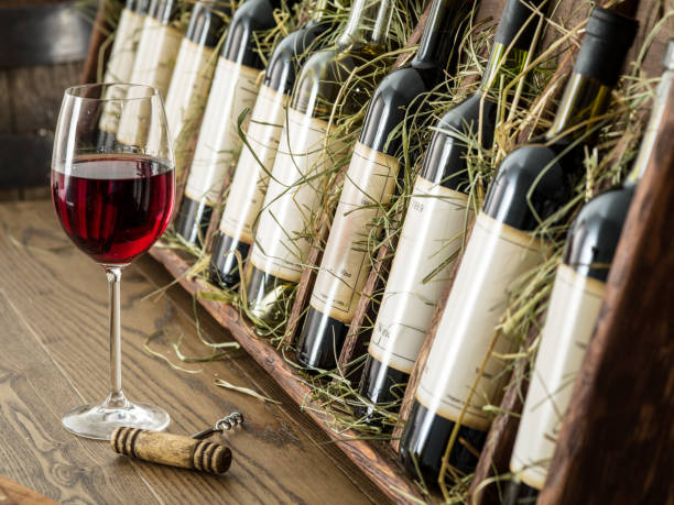istock Glass of red wine and wine bottles. 1087941386