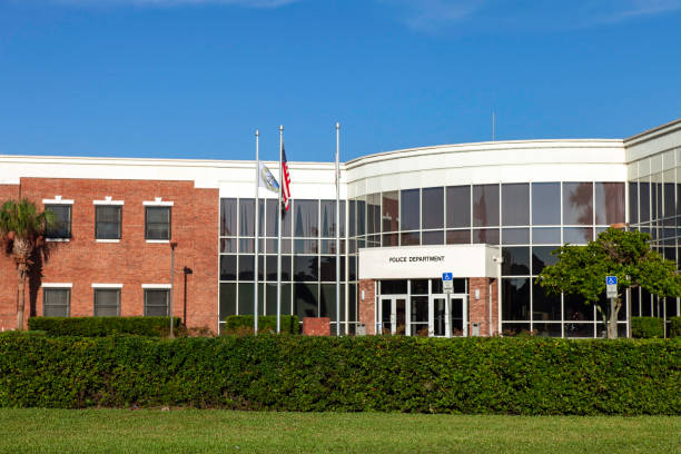 Modern Police Department Headquarters This is a Modern Police Department Headquarters under a clear blue sky and surrounded by well maintained Landscaping. police station stock pictures, royalty-free photos & images