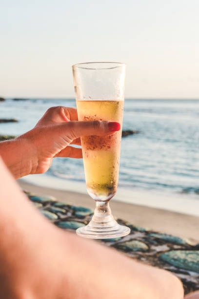 istock Drinking beer in front of the blue sea 1087957856