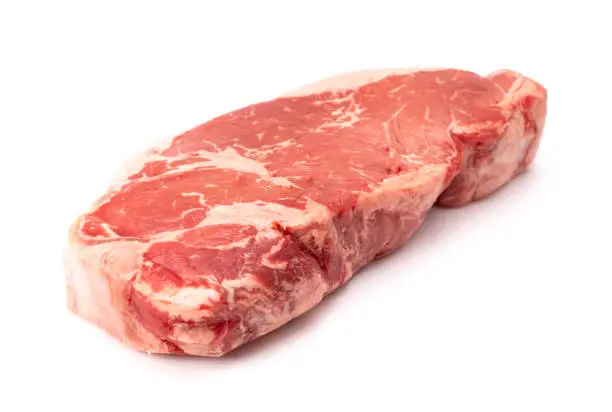 A Raw New York Strip Steak on a White Background