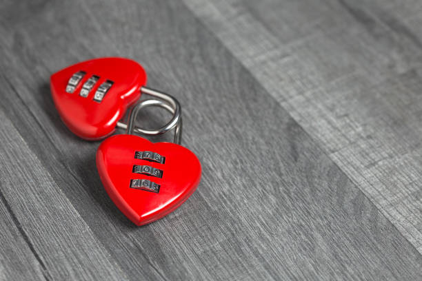 istock Valentine's Day background. Two red heart shape locks with copy space on wooden background 1087976626