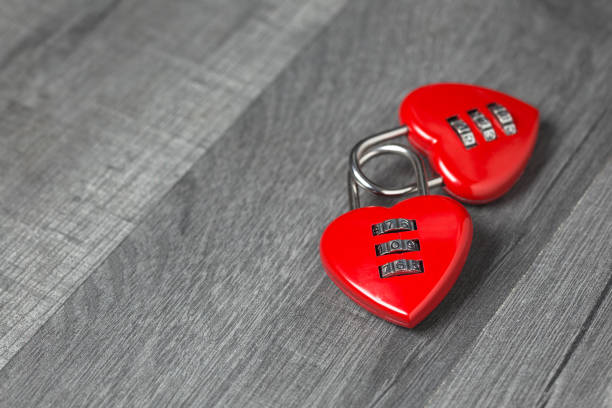 istock Valentine's Day background. Two red heart shape locks with copy space on wooden background 1087976630