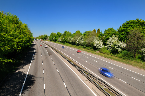 A wide angle horizontal view of cars traveling down a British motorway. XL image size.