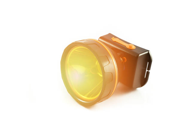 istock headlamp flashlight isolated With orange lights / black torch light on white background 1087982520