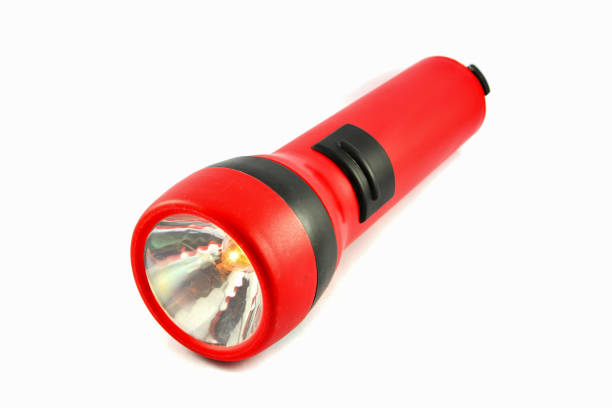 istock flashlight isolated With orange lights / Red torch light on white background 1087982576