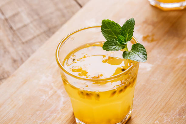 istock Glass of fresh passion fruit juice with mint on table 1088007824