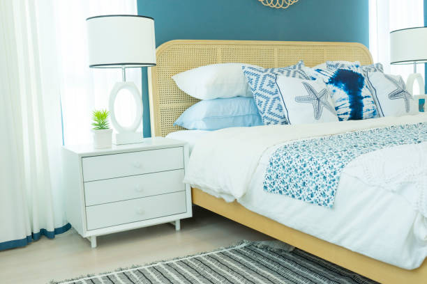 istock beautiful bedroom with blue wall and white table lamp. 1088023594
