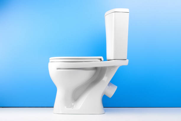 istock White toilet bowl on white blue background isolated. Side view 1088031928