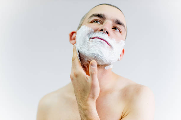 istock man is shaving his face in a bathroom 1088043618