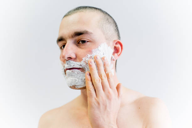 istock man is shaving his face in a bathroom 1088043620