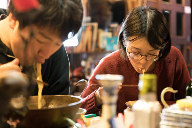 istock Man and woman eating ramen noodle 1088047316