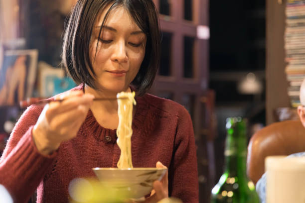 istock Mid woman eating noodle 1088047516