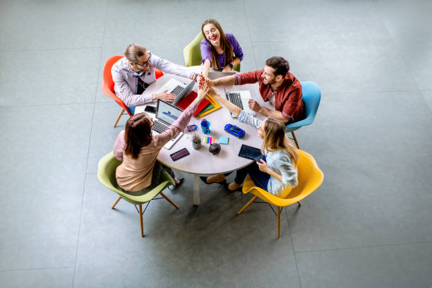 People working at the round table indoors