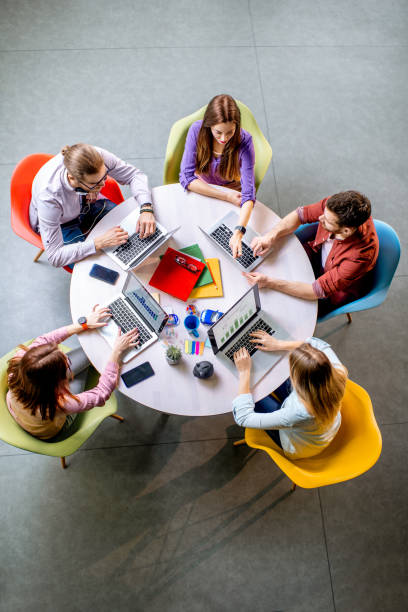 istock People working at the round table indoors 1088056054