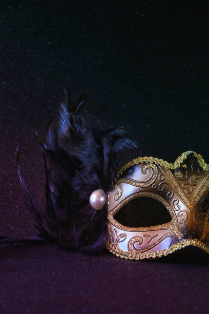 istock black venetian mask on glitter background 1088064064