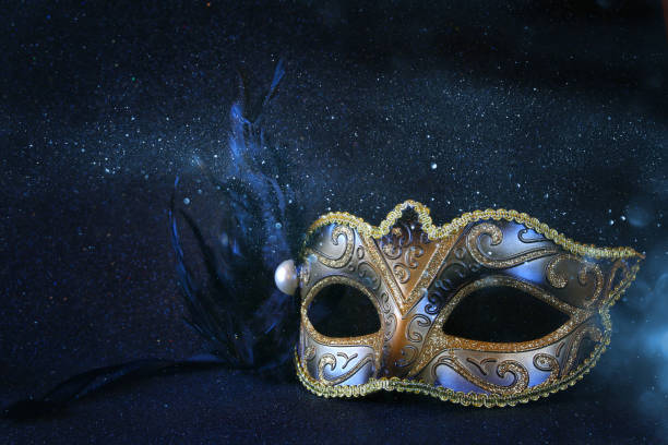 Image of black elegant venetian mask on glitter background