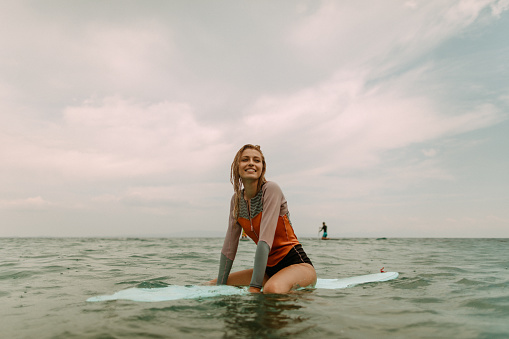 Surfer girl on a rainy day