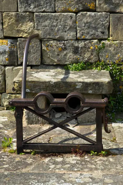 Photo of Old stocks outside the churchyard in Painswick