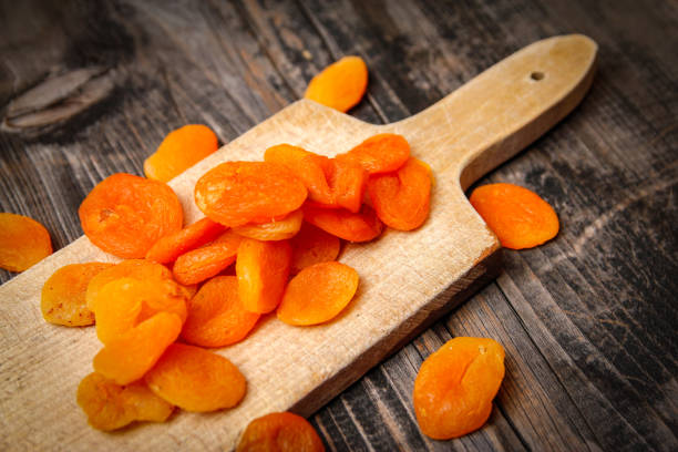 istock Dried apricots and kitchen cutting board 1088071442
