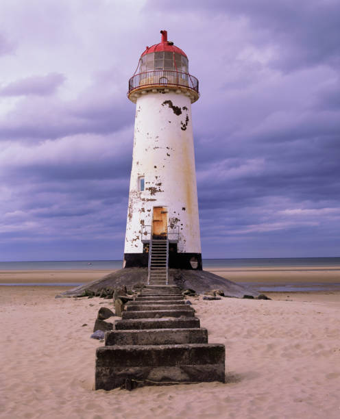 istock a stone pathway leading to an old white lighthouse with a red roof on a sandy beach 1088074596