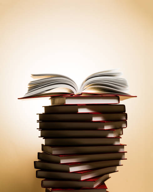 istock An open book on a stack of red books in the form of a spiral. 1088077132