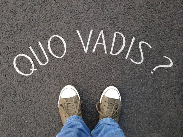 quo vadis is a latin phrase meaning where are you going - foot selfie on street with question written on asphalt - confusion destiny uncertainty concept