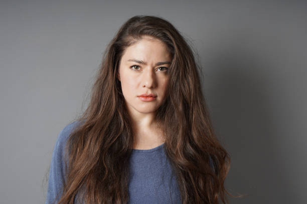 istock young woman with serious look on her face 1088082078