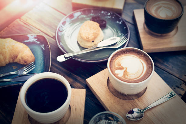 istock Breakfast with coffee and bread on wooden table. 1088089978