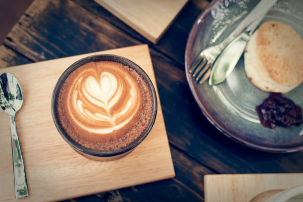 istock Coffee cup with bread on wooden table. 1088090014