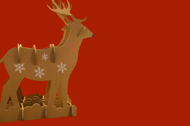 istock horizontal image of a cardboard construction representing a reindeer used as a Christmas decoration with a red background 1088098970