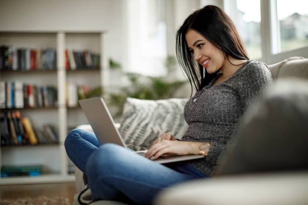 Young woman working on a laptop computer at home