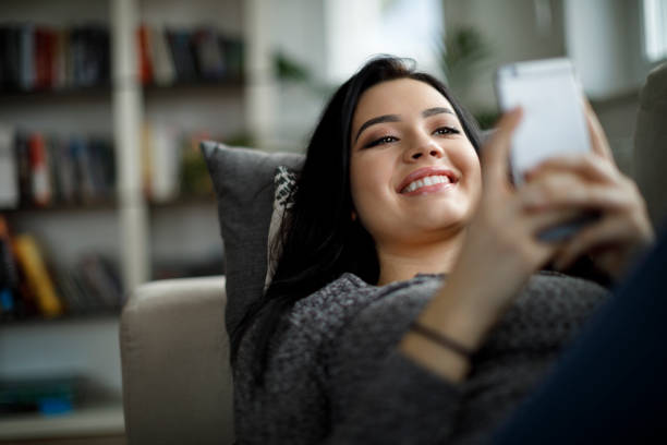 istock Teenager relaxing on sofa with mobile phone 1088104862
