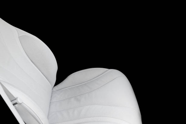 istock White leather interior of a car. Perforated Leather comfortable seats with stitching isolated on black background. Car interior details. Car detailing. Car inside 1088105448