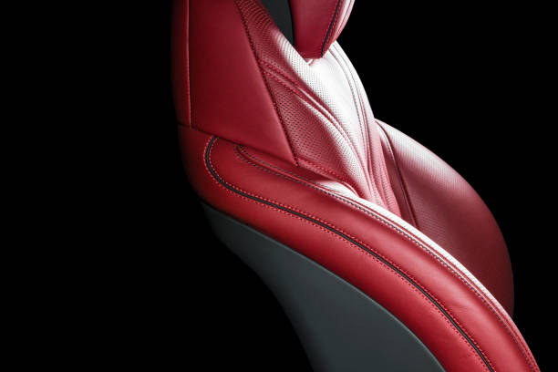 istock Red leather interior of a car. Perforated Leather comfortable seats with stitching isolated on black background. Car interior details. Car detailing. Car inside 1088105654