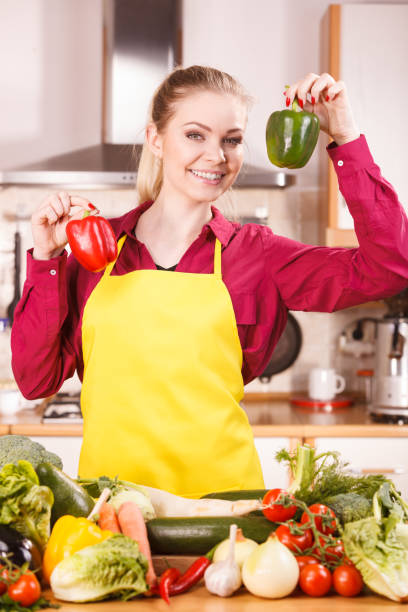 istock Woman holding two bell peppers 1088105694