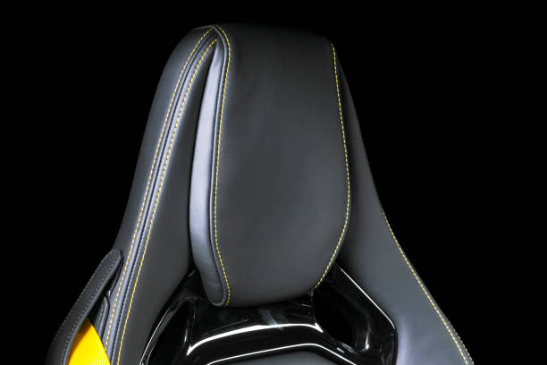 istock Black leather interior of a car. Perforated Leather comfortable seats with yellow stitching isolated on black background. Car interior details. Car detailing. Car inside 1088106848