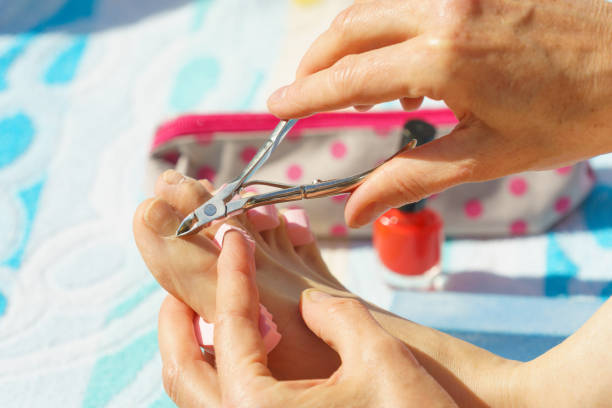 istock Woman trimming cuticles before pedicure 1088107164