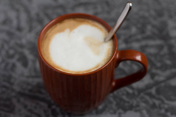 istock hot cappuccino coffee in a brown mug on a gray background 1088110970