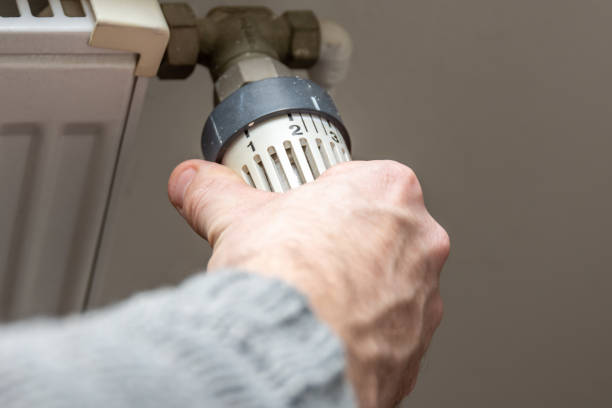 istock Male hand changing temperature on radiator 1088117678