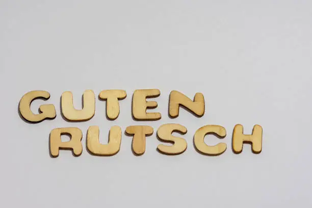 Lettering Guten Rutsch, laid out of sawn-out wooden letters