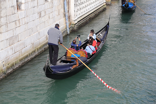 Gondolas with tourists in Venice, Italy on September 30, 2918