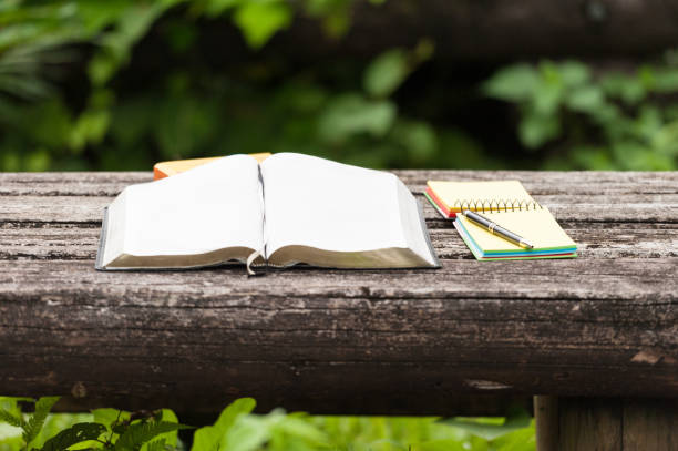 istock Bible Open With Pen and Notes on a Wooden Table Outdoors 1088126168
