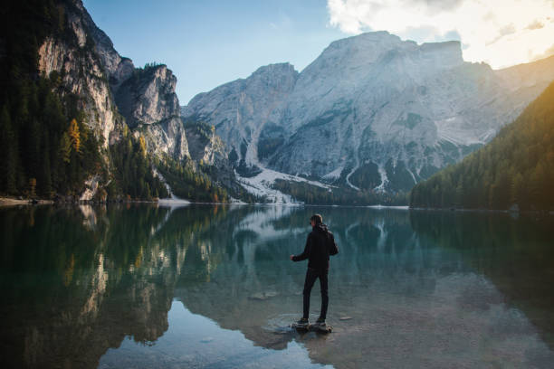 istock Man Standing on Rock at Beautiful Alpine Lake 1088129608