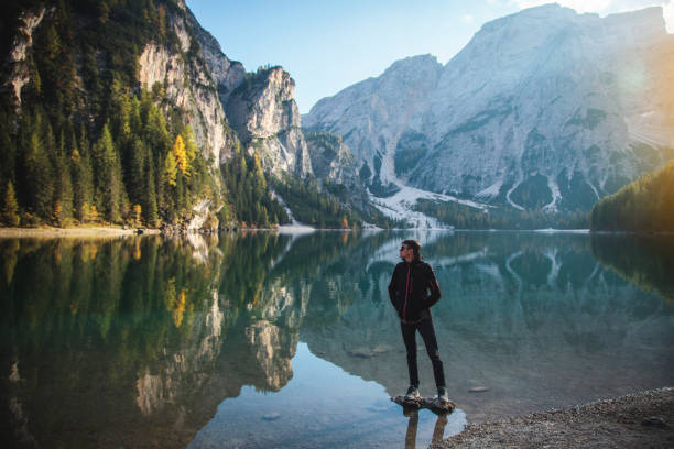 istock Man Standing on Rock at Beautiful Alpine Lake 1088129710