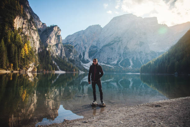 istock Man Standing on Rock at Beautiful Alpine Lake 1088132604