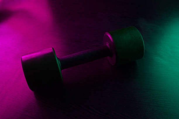 istock metal barbell on dark background 1088133070