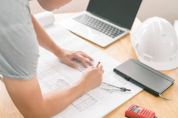 istock architect or civil engineer during drawing home or building in office on working table with office stationary , laptop ,color pallette sampling. 1088134528